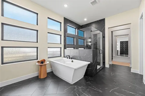 a spacious bathroom with a double vanity sink a mirror and a bathtub