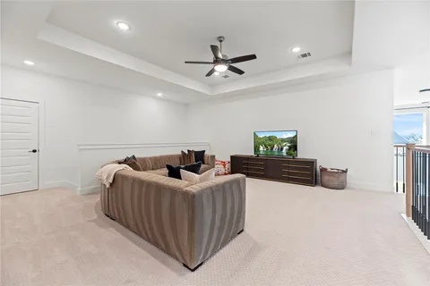 a bedroom with furniture and a ceiling fan