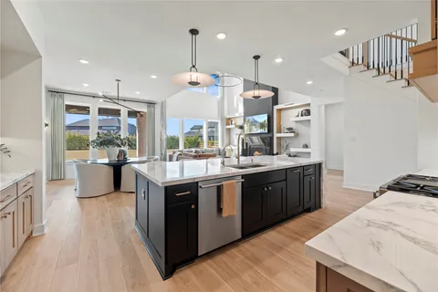 a large kitchen with stainless steel appliances kitchen island granite countertop a large counter top and stove