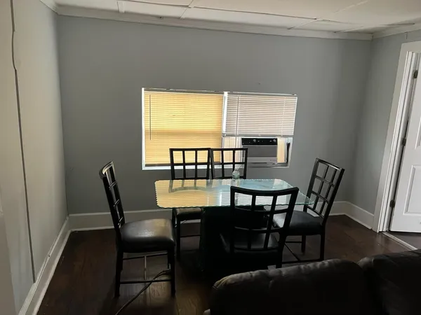 a view of a dining room with furniture and window