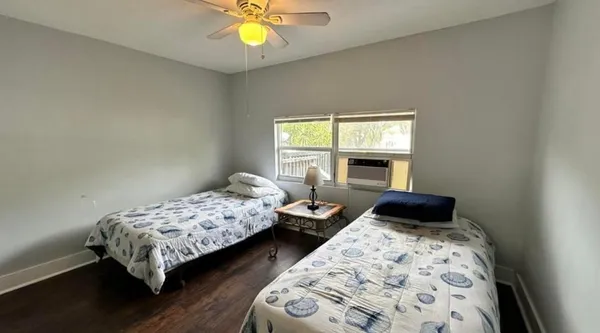 a bedroom with bed and a window