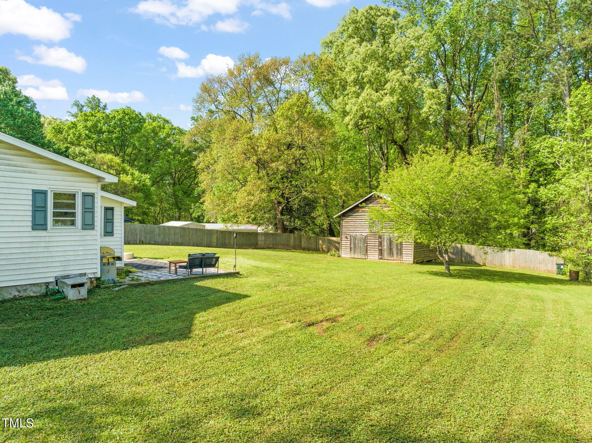 12601 Boyce Mill Road Raleigh, NC 27613 - Photo 22 of 35 a view of a house with a yard and sitting area