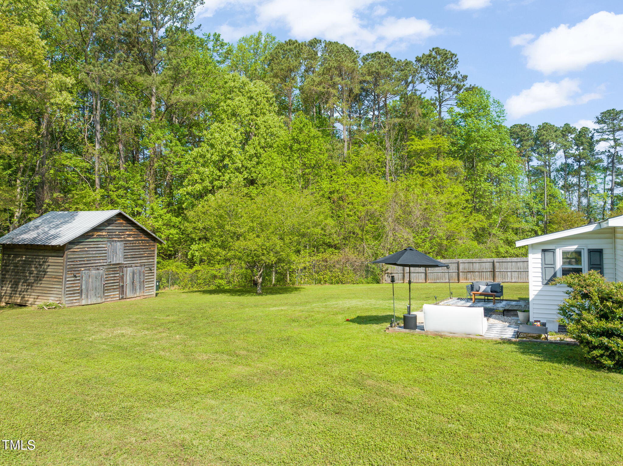 12601 Boyce Mill Road Raleigh, NC 27613 - Photo 26 of 35 a view of a house with a backyard and a patio