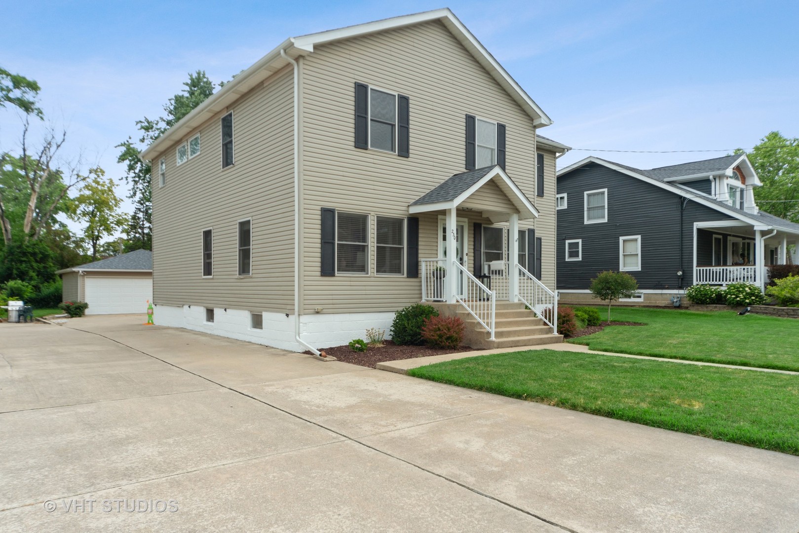 230 West Harrison Road Lombard, IL 60148 - Photo 28 of 31 a front view of a house with a yard and garage