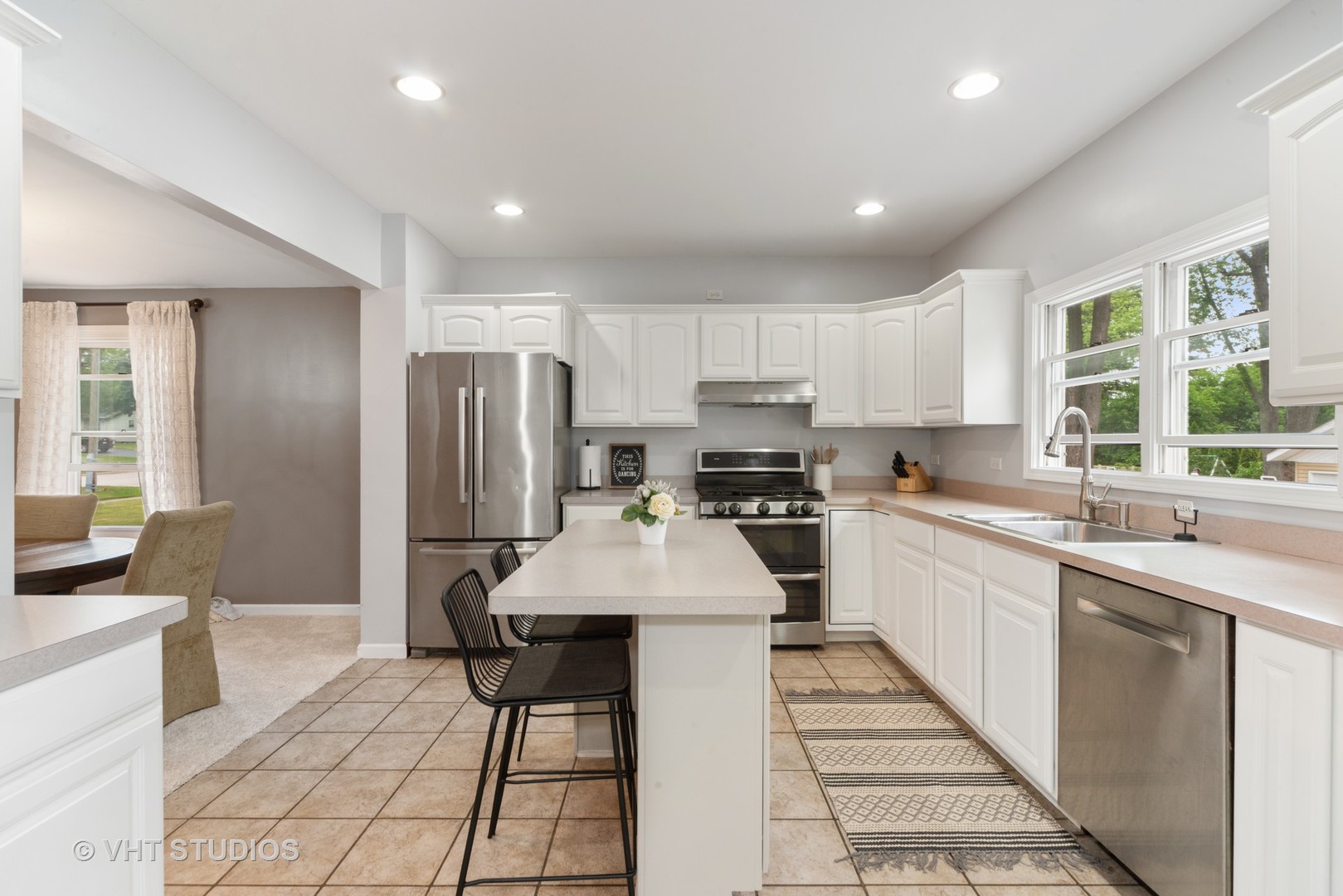 230 West Harrison Road Lombard, IL 60148 - Photo 6 of 31 a kitchen with stainless steel appliances a refrigerator stove microwave and sink