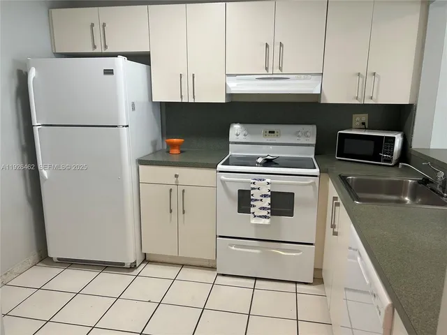 a kitchen with appliances and cabinets