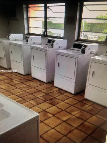a kitchen with a sink cabinets and window