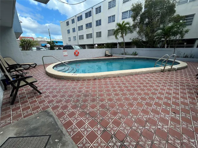 a view of a swimming pool with a patio