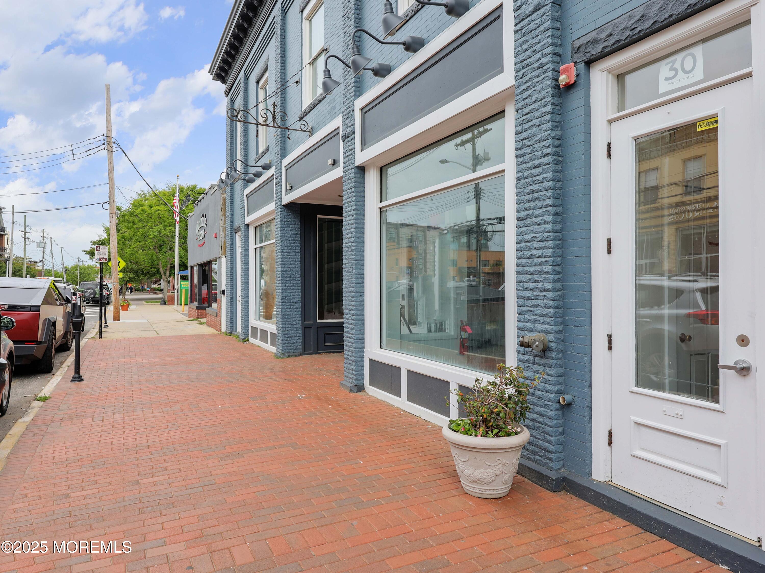 30 West Front Street, Unit E Red Bank, NJ 07701 - Photo 15 of 17 a view of a brick house with potted plants and a building