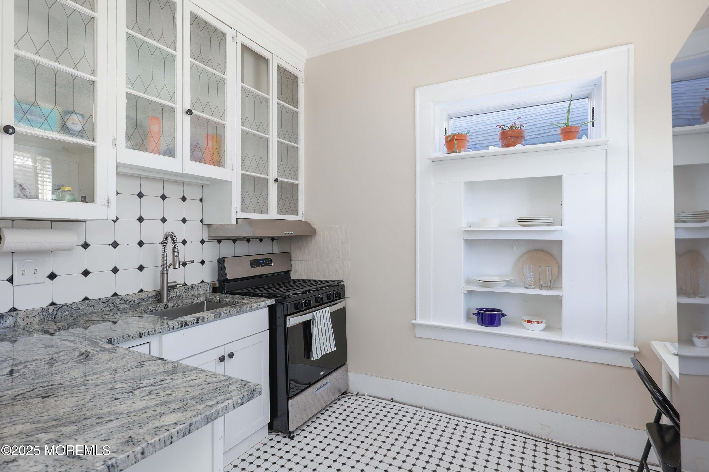30 West Front Street, Unit E Red Bank, NJ 07701 - Photo 4 of 17 a kitchen with granite countertop a stove and a cabinets