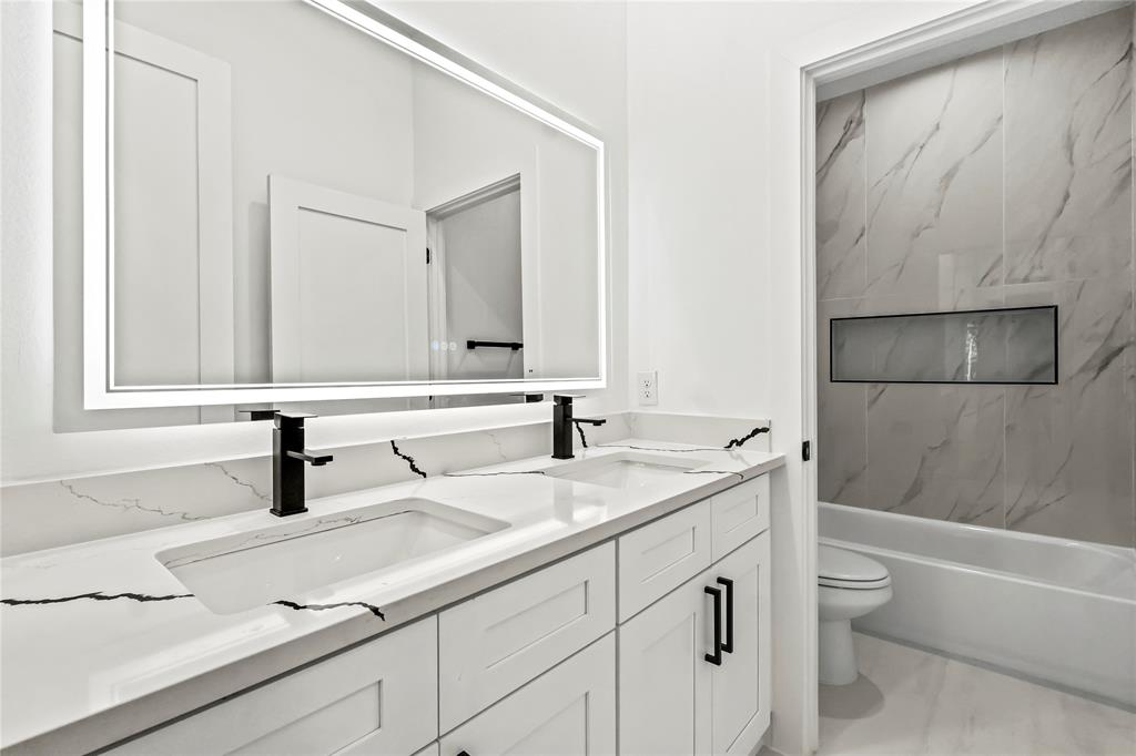1720 Morris Street Dallas, TX 75212 - Photo 1 of 1 a bathroom with a sink and a mirror