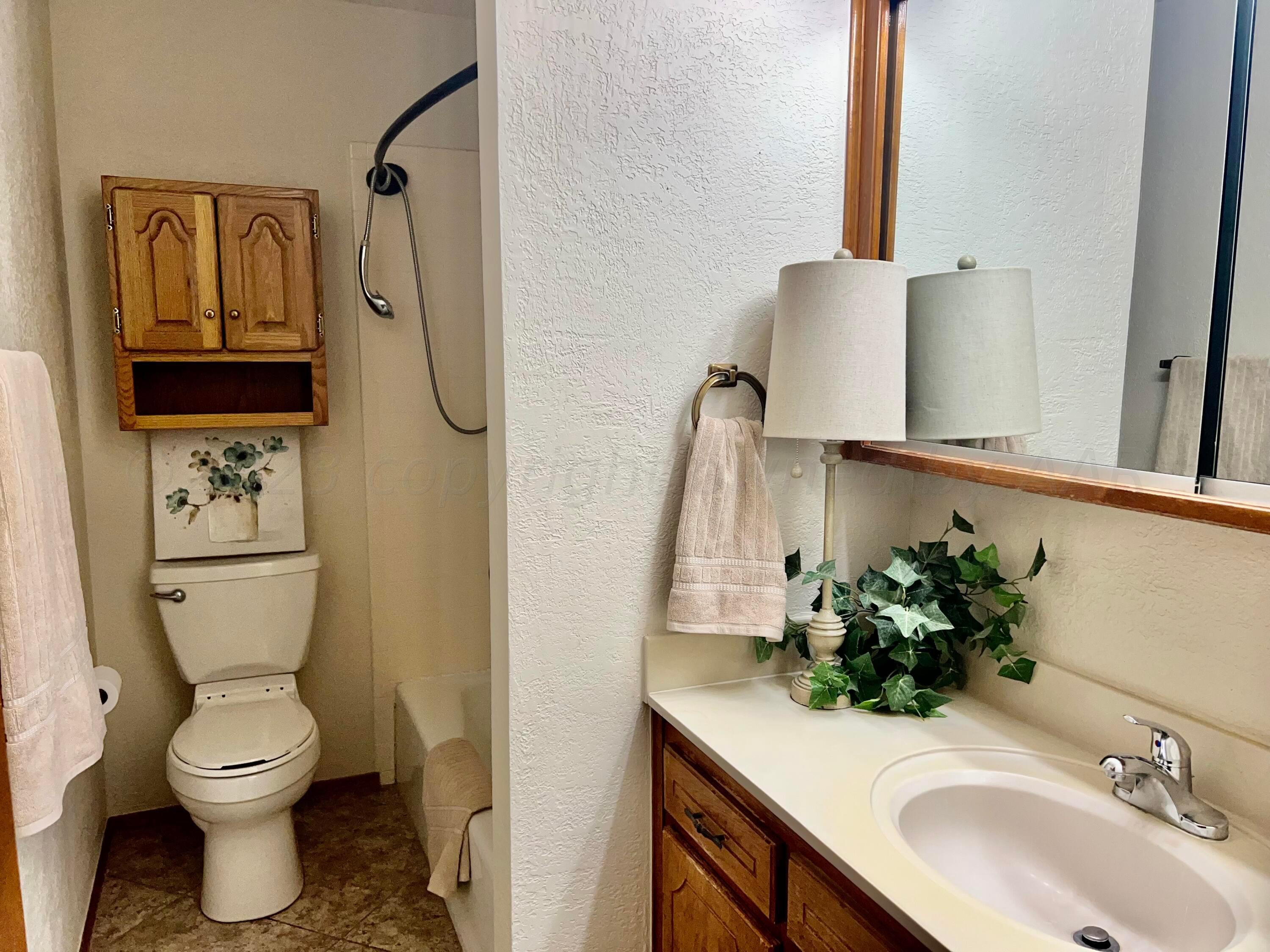 3416 B Gladstone Lane Amarillo, TX 79121 - Photo 11 of 17 a bathroom with a sink toilet and mirror