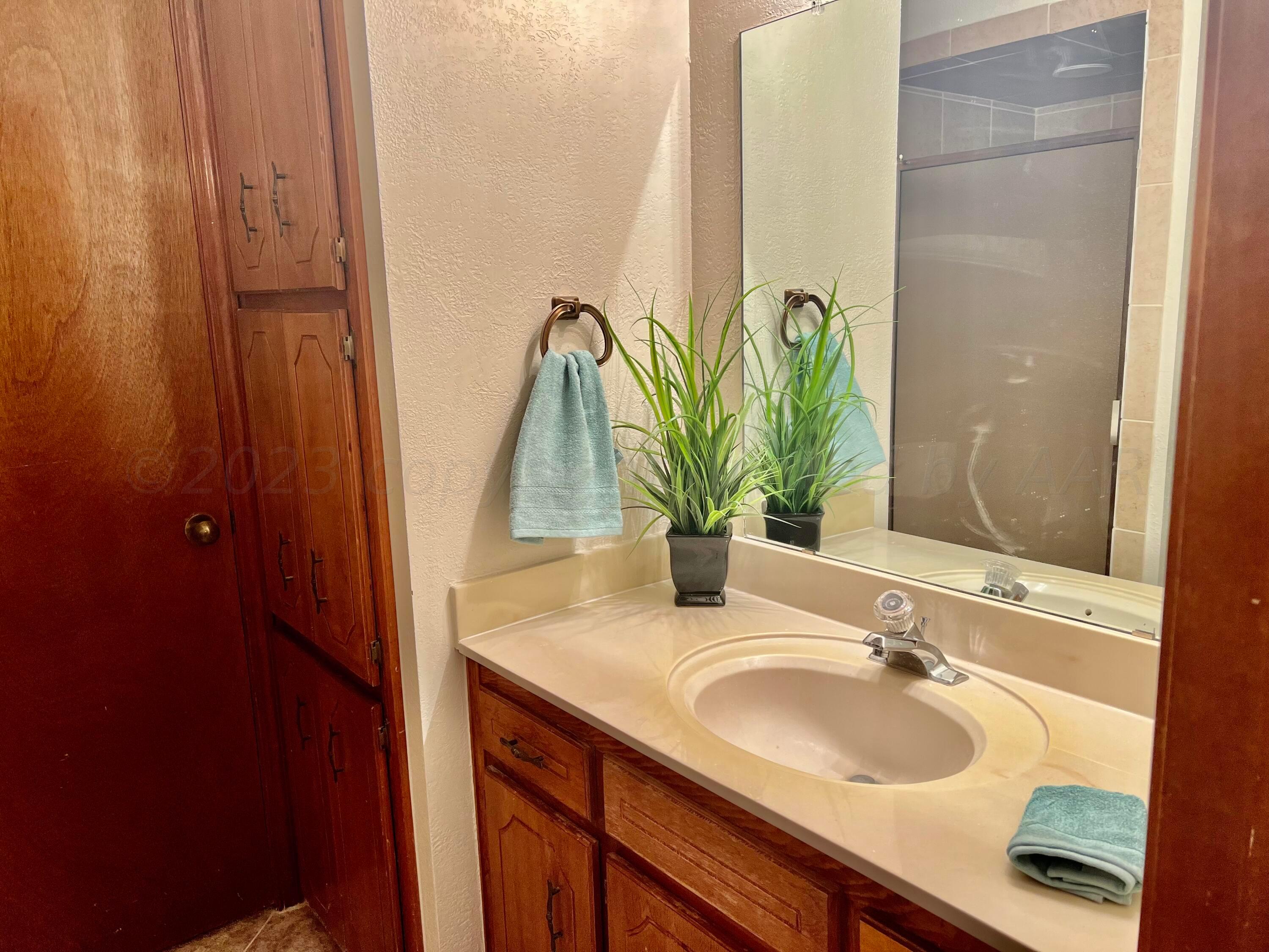 3416 B Gladstone Lane Amarillo, TX 79121 - Photo 13 of 17 a bathroom with a sink and a mirror