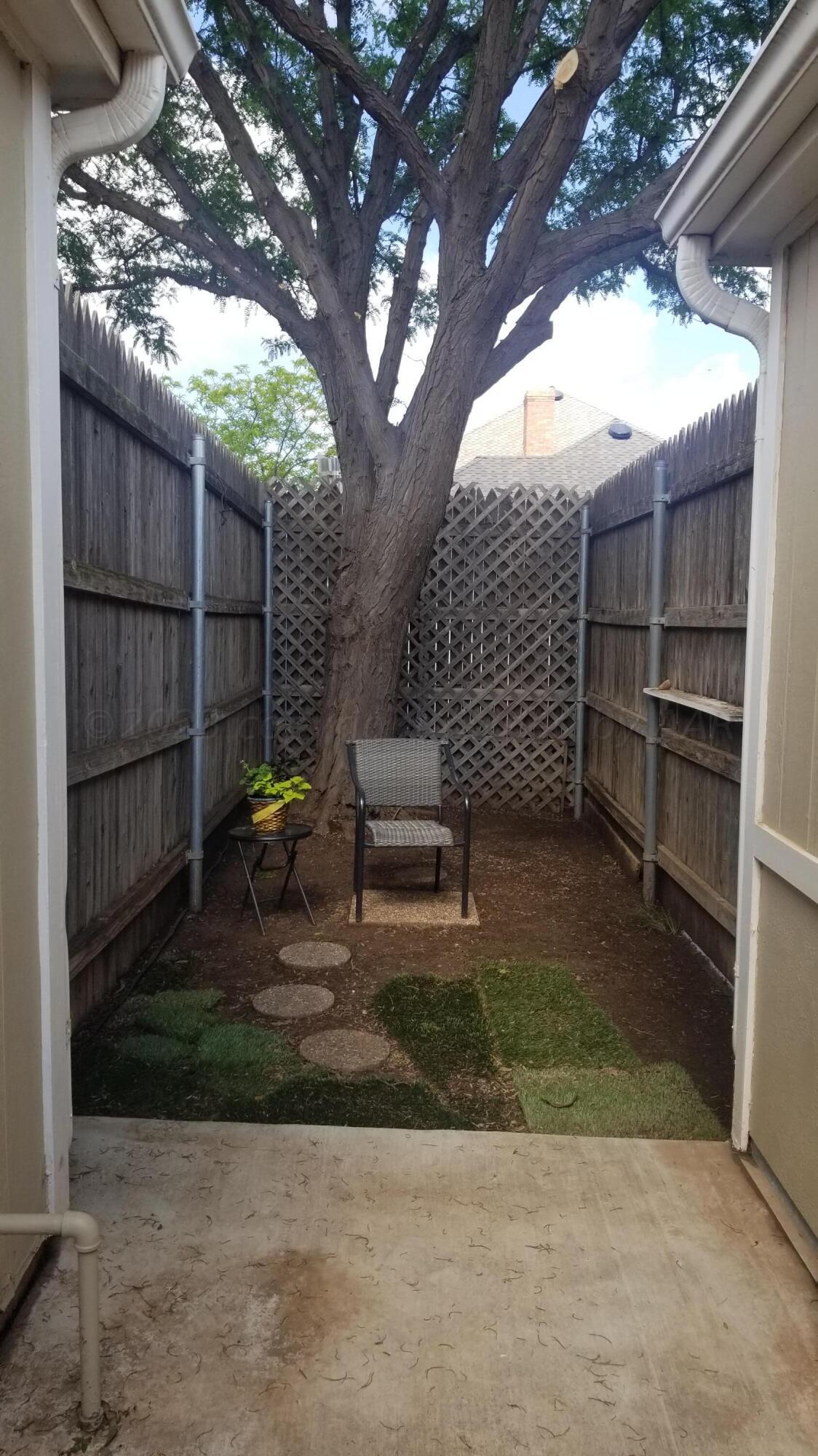 3416 B Gladstone Lane Amarillo, TX 79121 - Photo 17 of 17 a wooden bench sitting in front of a building