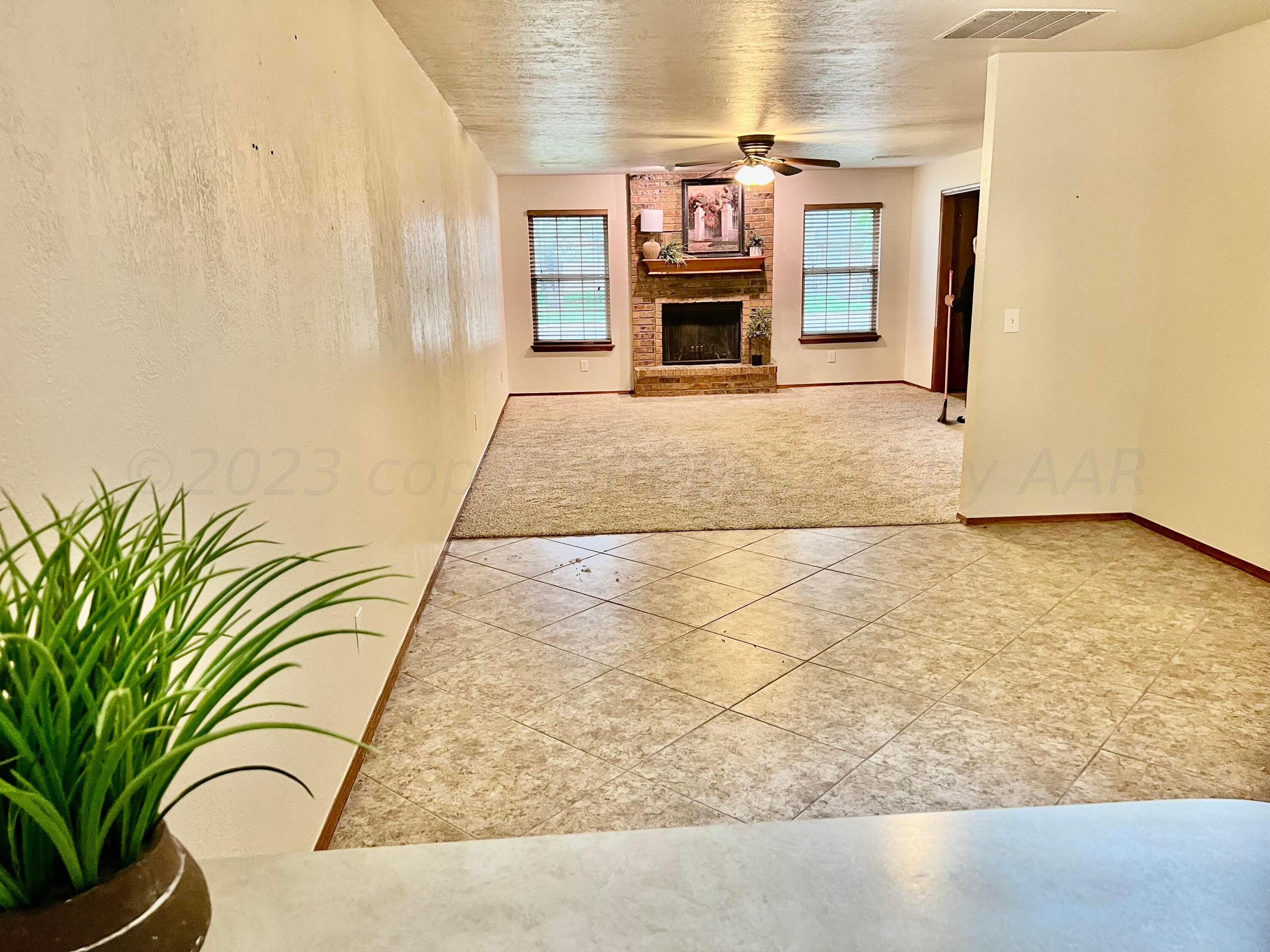 3416 B Gladstone Lane Amarillo, TX 79121 - Photo 4 of 17 a view of living room filled with furniture and fireplace