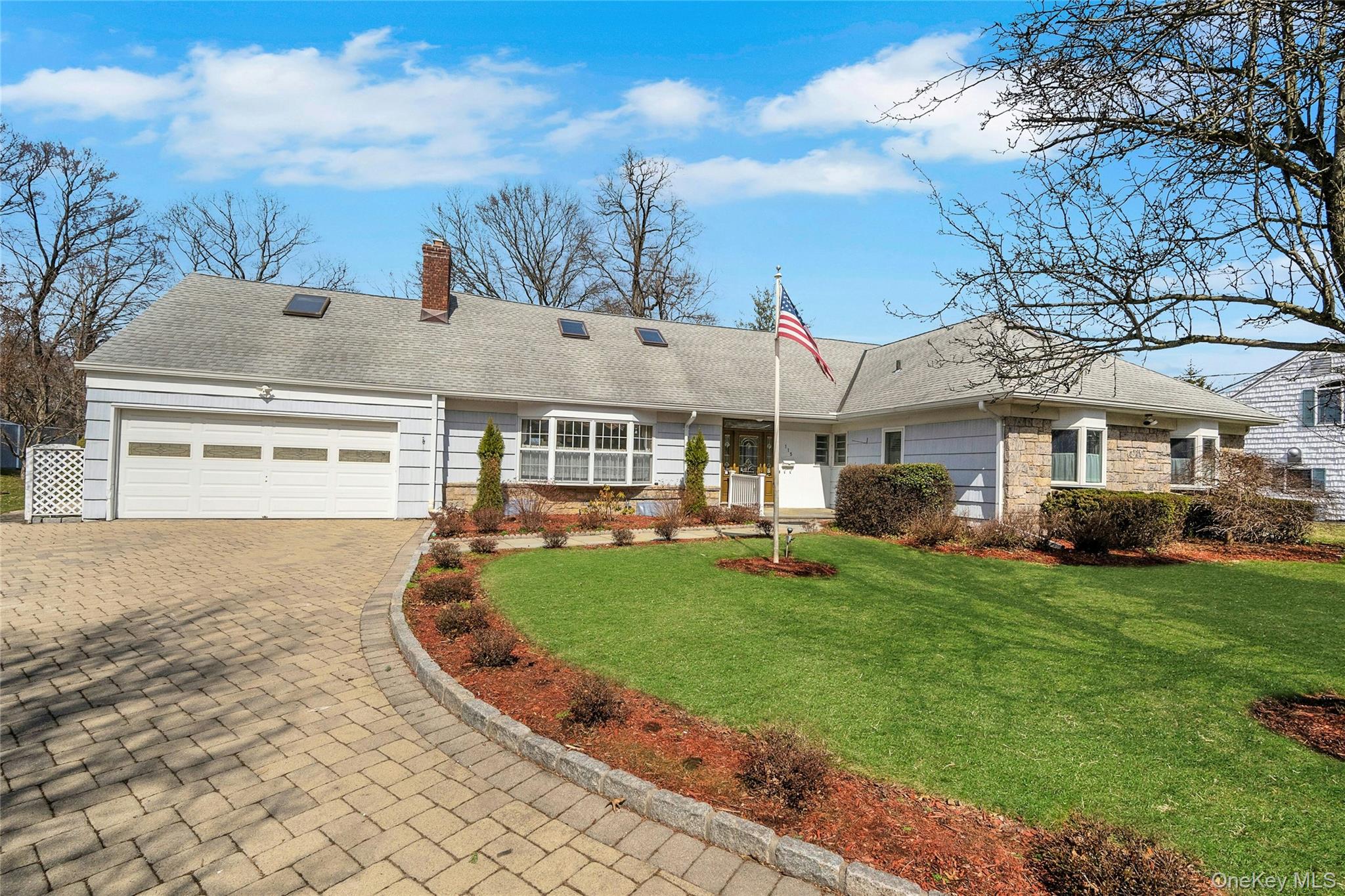 a front view of a house with a garden and yard