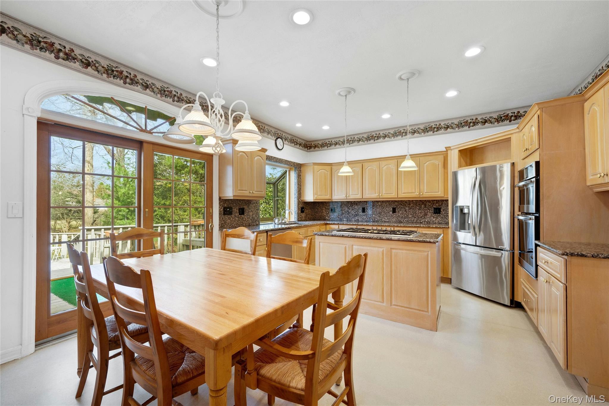 115 Elizabeth Road New Rochelle, NY 10804 - Photo 21 of 47 a kitchen with stainless steel appliances granite countertop a stove a refrigerator a kitchen island with a stove and white cabinets
