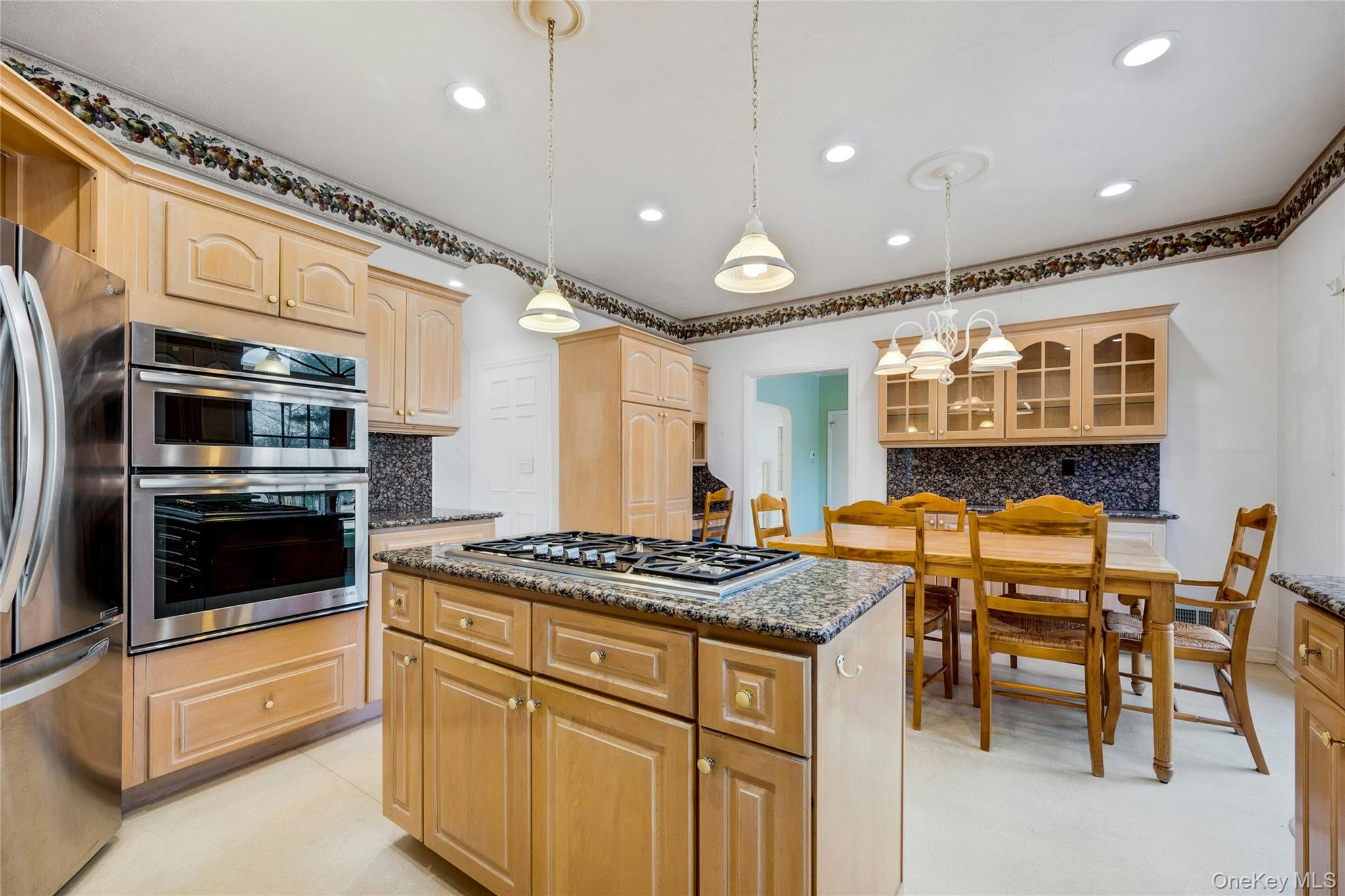 115 Elizabeth Road New Rochelle, NY 10804 - Photo 23 of 47 a kitchen with stainless steel appliances granite countertop a stove a sink and a microwave