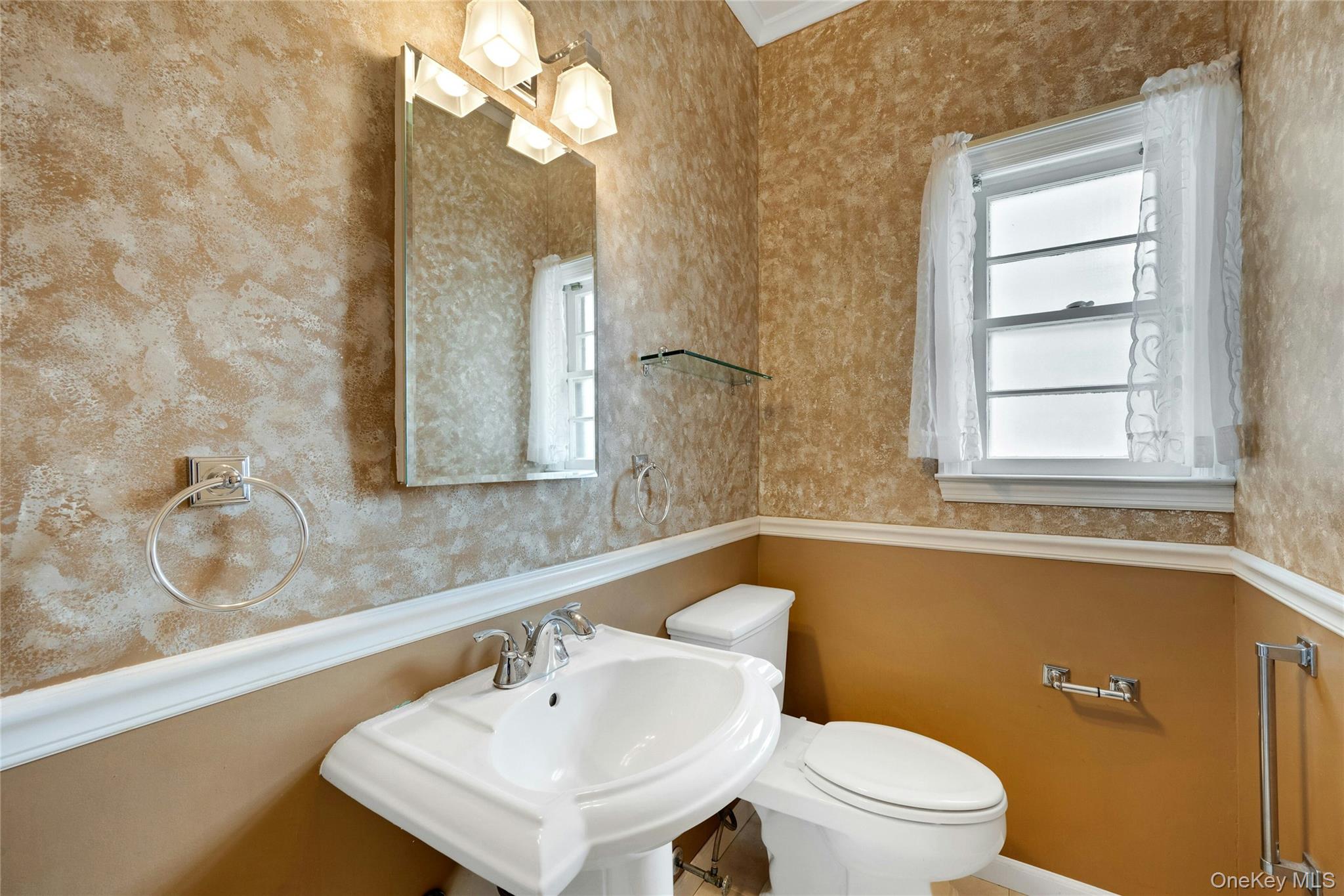 115 Elizabeth Road New Rochelle, NY 10804 - Photo 24 of 47 a bathroom with a sink a toilet and a mirror