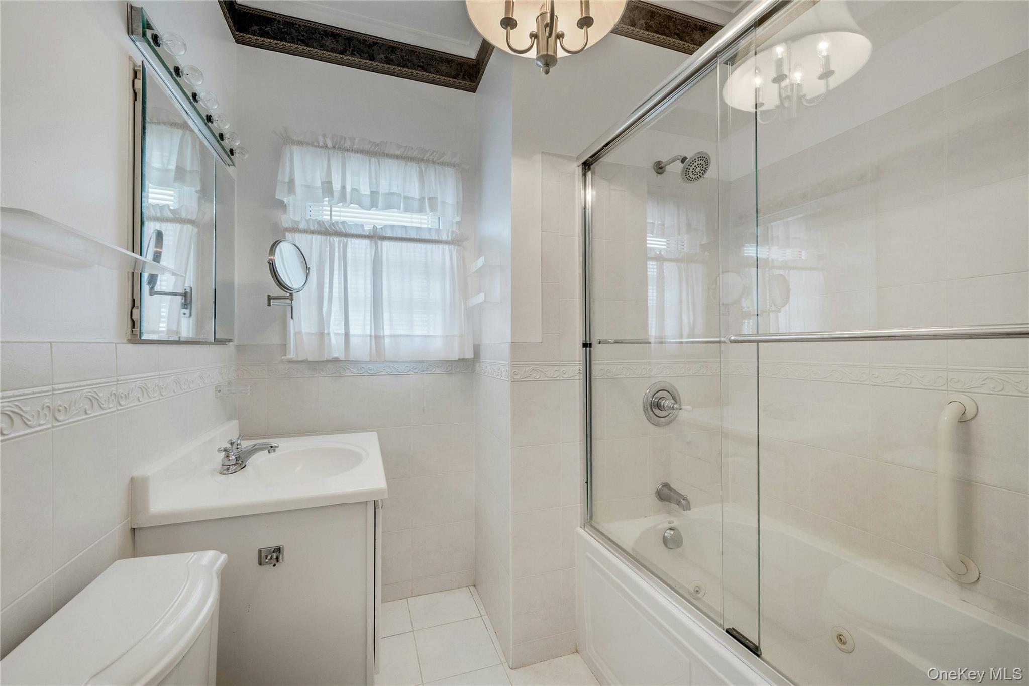 115 Elizabeth Road New Rochelle, NY 10804 - Photo 25 of 47 a bathroom with a bathtub shower sink mirror and toilet