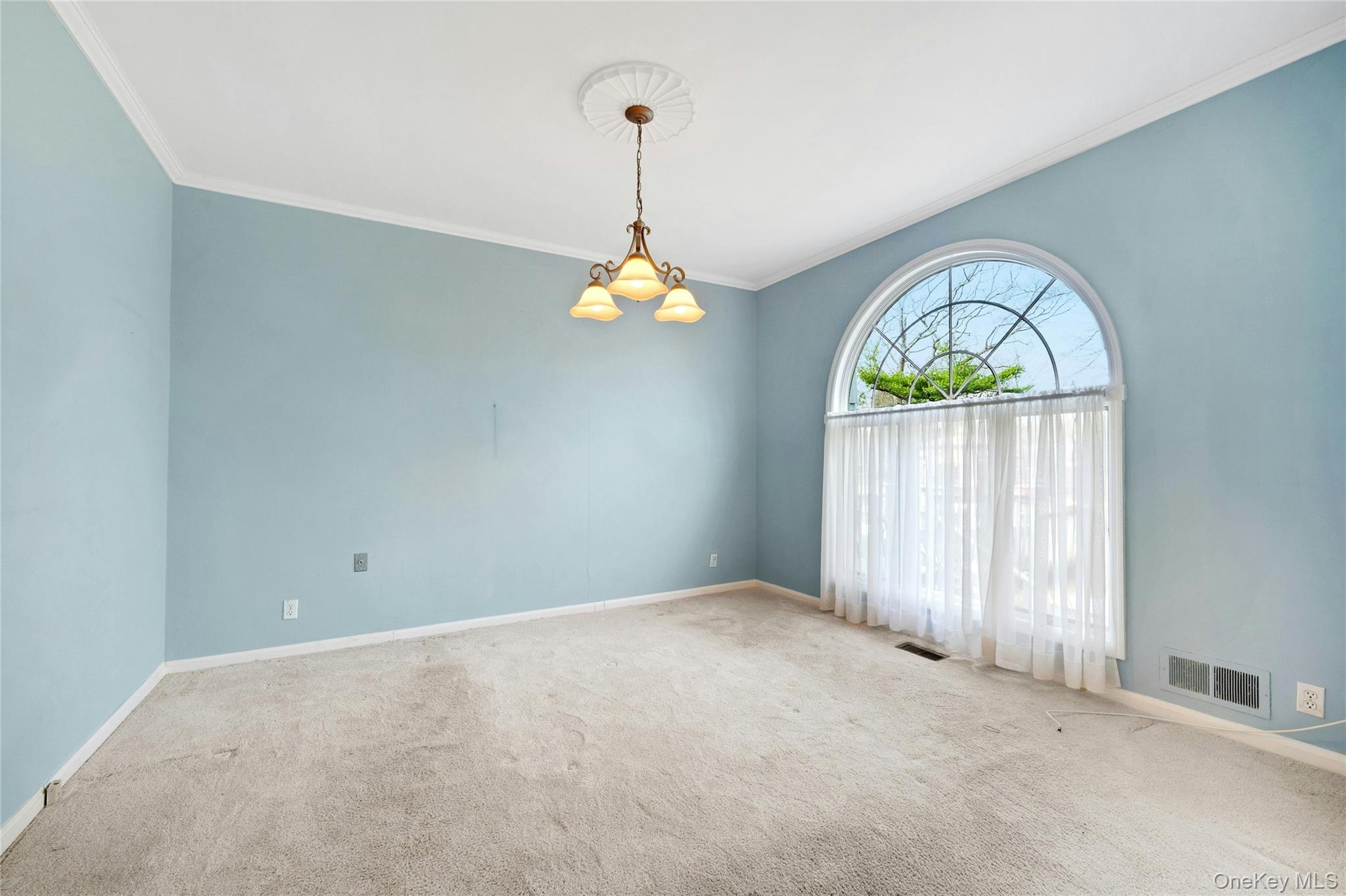 115 Elizabeth Road New Rochelle, NY 10804 - Photo 30 of 47 a view of a room with window wooden floor and a chandelier
