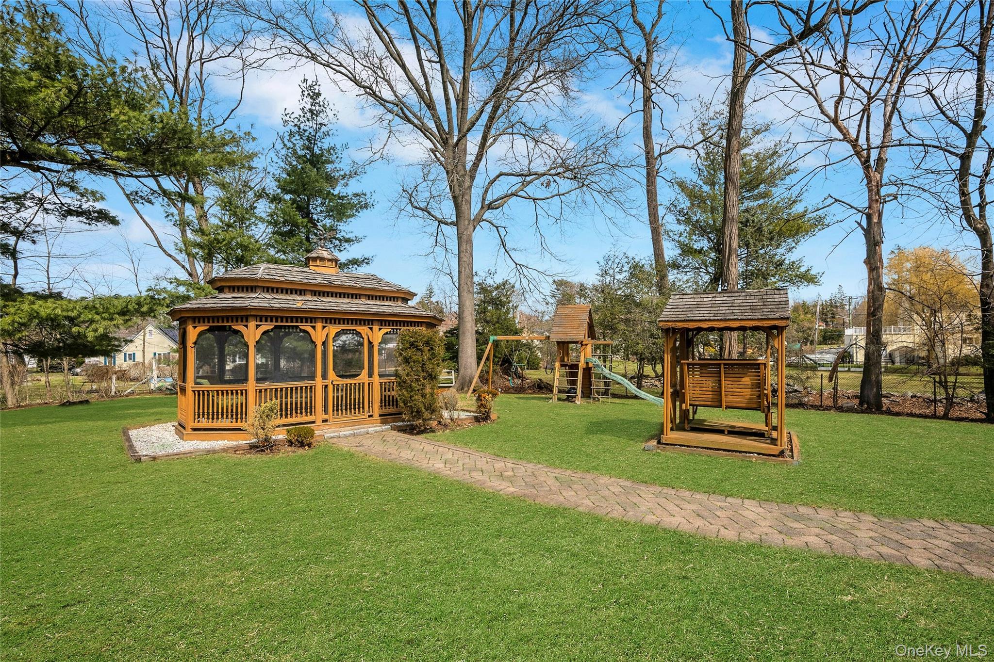 115 Elizabeth Road New Rochelle, NY 10804 - Photo 4 of 47 a front view of a house with a yard table and chairs