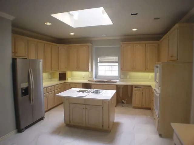 a kitchen with a refrigerator stove a sink dishwasher and microwave oven
