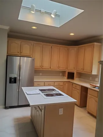a kitchen with a sink a stove a refrigerator and cabinets