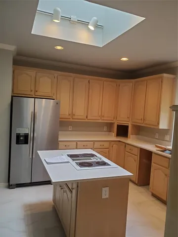 a kitchen with a sink a stove a refrigerator and cabinets