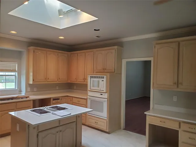 a kitchen that has a sink and a stove in it