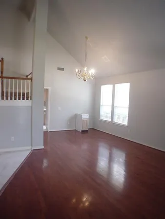 a view of a room with window and hardwood floor