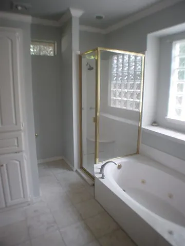 a bathroom with a bathtub a shower and a sink