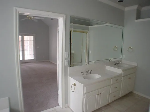 a bathroom with a sink double vanity and a mirror