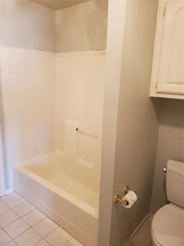 a white bath tub sitting next to a white toilet
