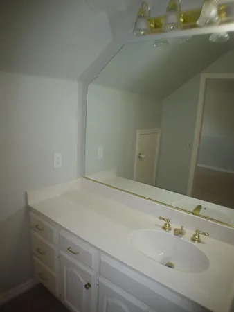 a bathroom with a sink and vanity