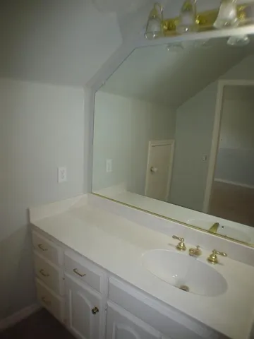 a bathroom with a sink and vanity