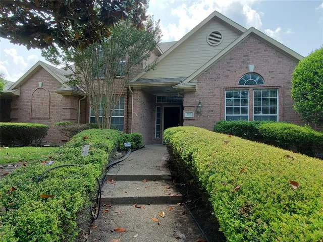 a front view of a house with a yard and pathway
