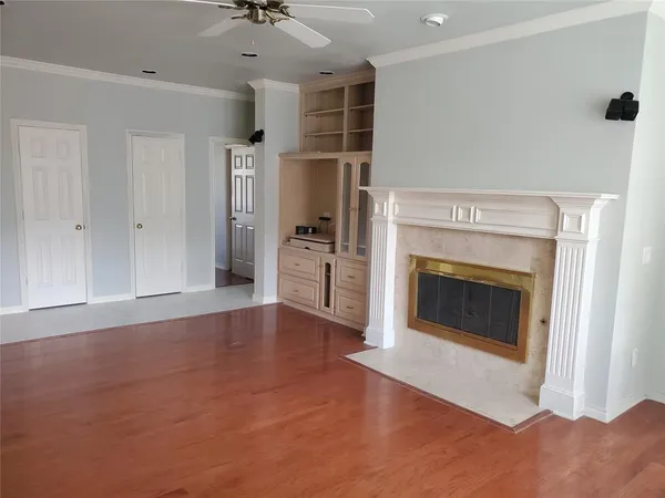 a view of an empty room with a fireplace and a window