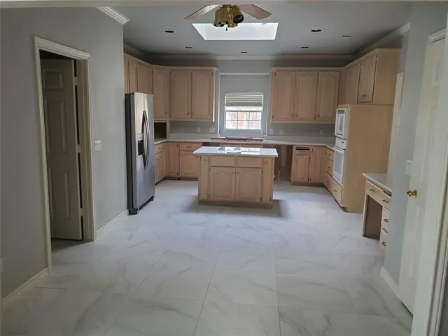 a kitchen with refrigerator and window