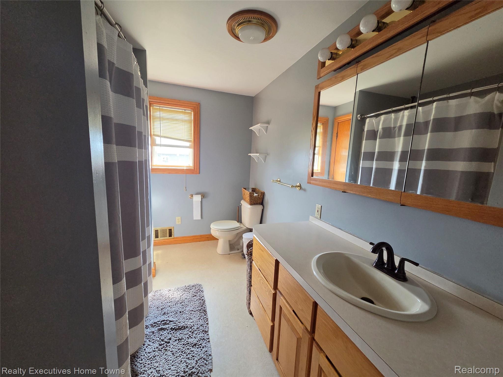2715 Cash Road Applegate, MI 48401 - Photo 35 of 59 Lower level full bathroom featuring a light-toned vanity with an integrated sink and matte black faucet