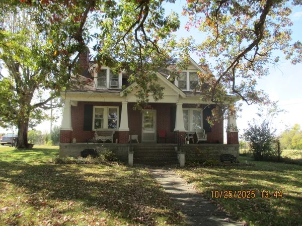 a front view of a house with a yard garage and outdoor seating