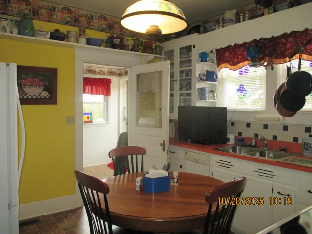 a view of a dining room with furniture and chandelier
