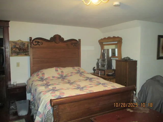 a bed sitting in a bedroom and dressers