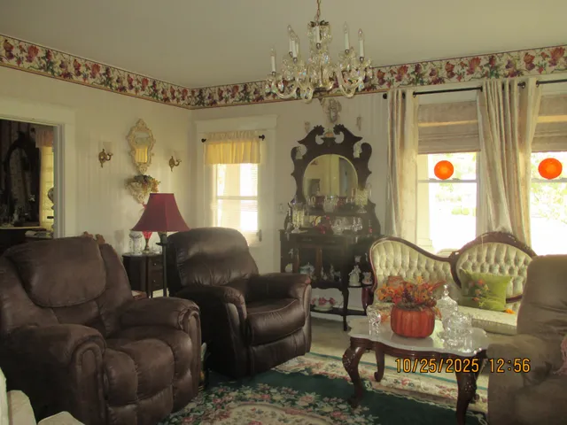 a living room with furniture and a chandelier