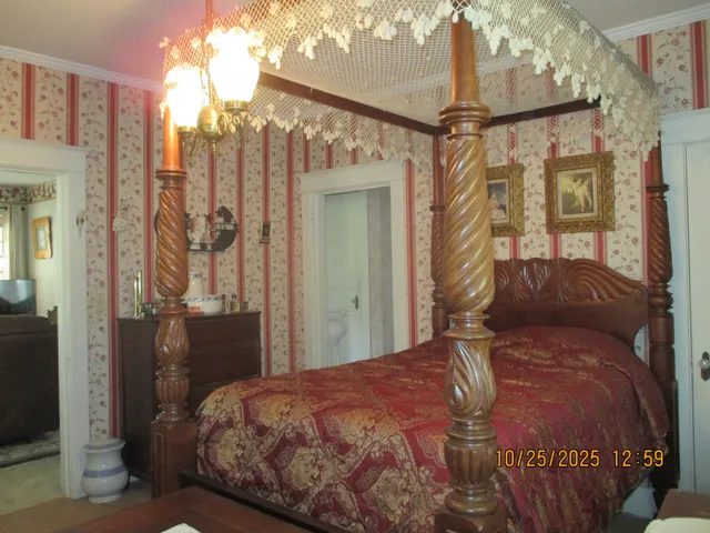 a bedroom with a bed and a mirror