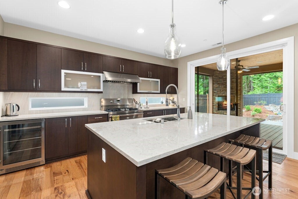 6578 Serenity Loop Gig Harbor, WA 98335 - Photo 11 of 38 a kitchen with a stove a refrigerator a sink dishwasher with a dining table and chairs