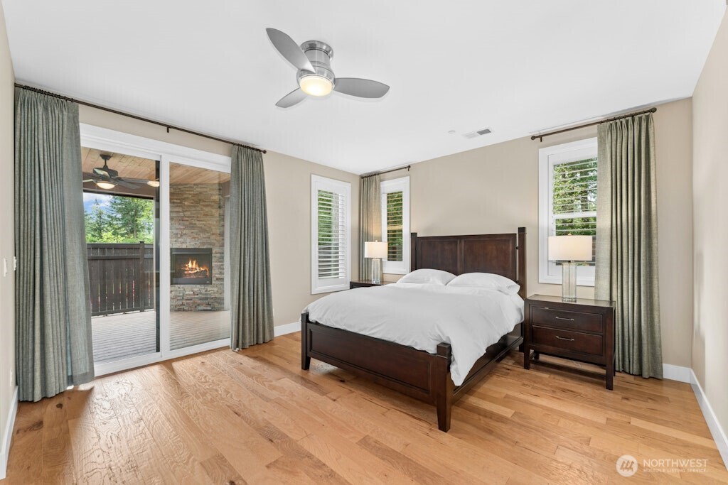 6578 Serenity Loop Gig Harbor, WA 98335 - Photo 15 of 38 a bedroom with a large bed and a large window