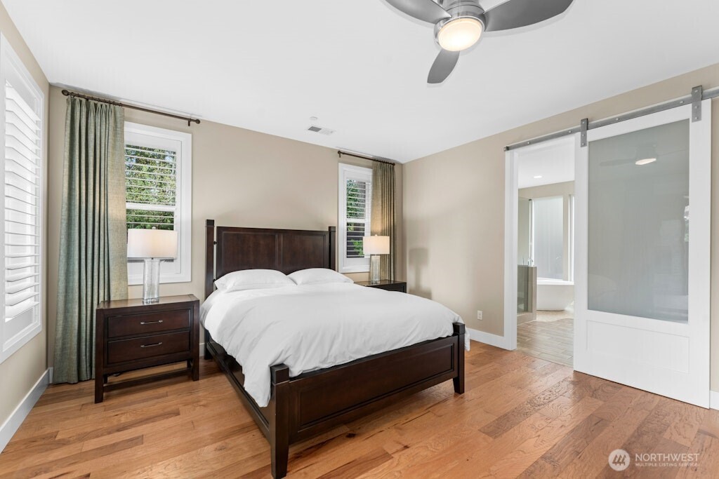 6578 Serenity Loop Gig Harbor, WA 98335 - Photo 16 of 38 a bedroom with a bed lamp and window