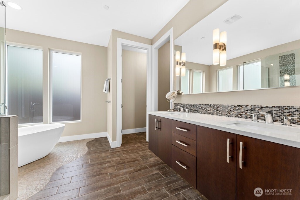 6578 Serenity Loop Gig Harbor, WA 98335 - Photo 17 of 38 a spacious bathroom with a granite countertop sink a mirror and a bathtub