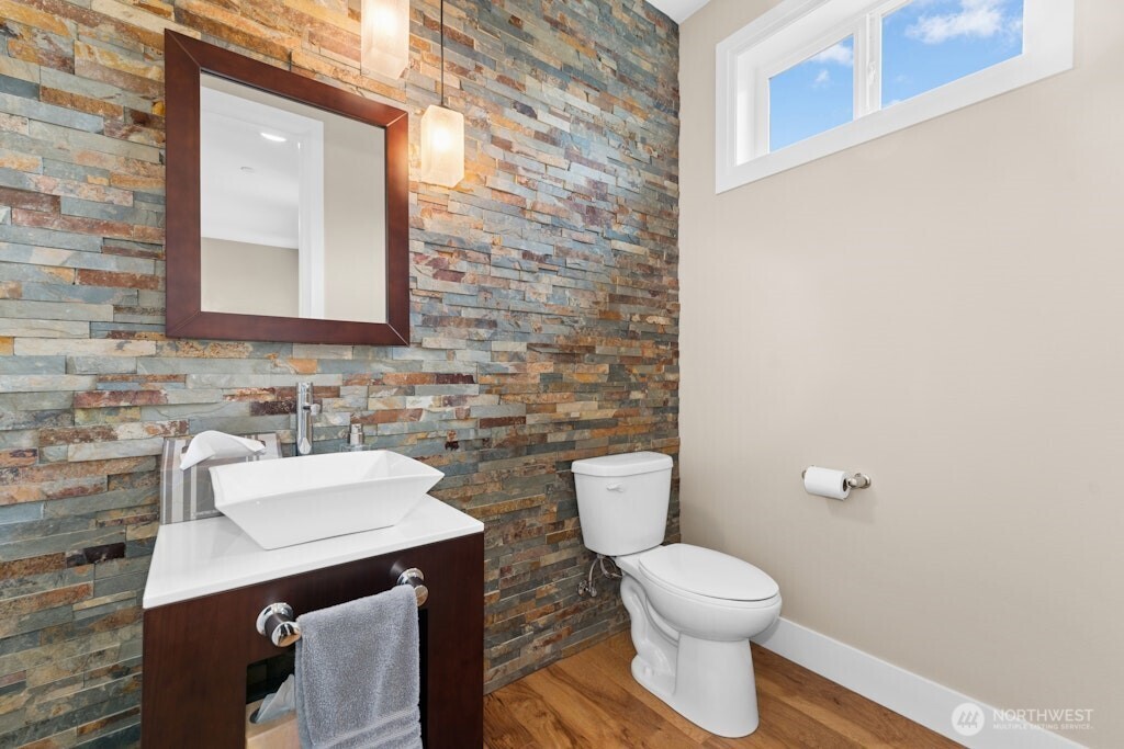 6578 Serenity Loop Gig Harbor, WA 98335 - Photo 21 of 38 a bathroom with a toilet a sink and mirror